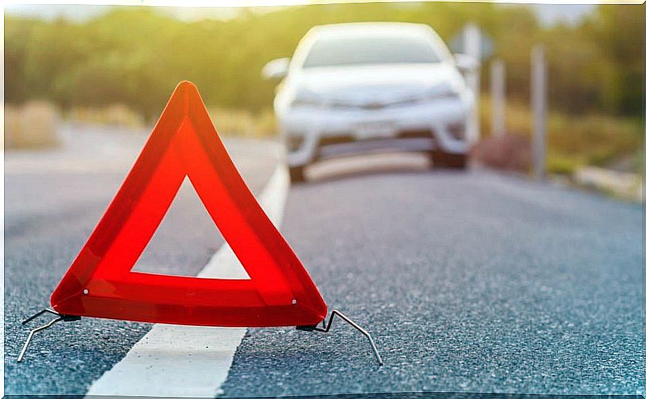 Warning triangle positioned to change the wheel on the road