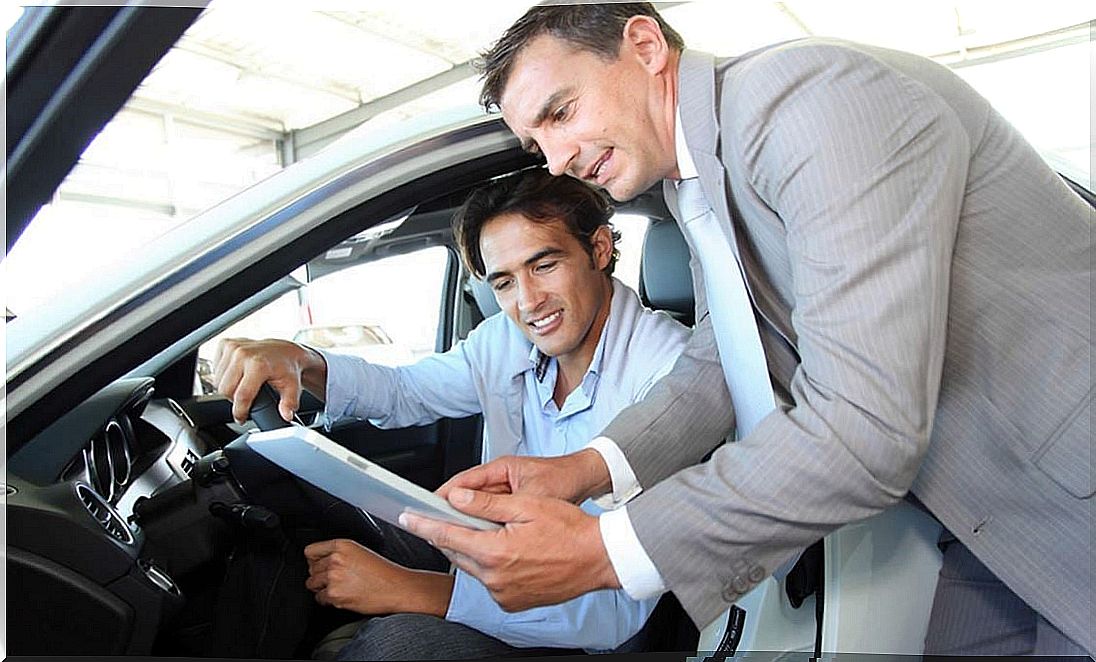 Man looking at a car before buying.